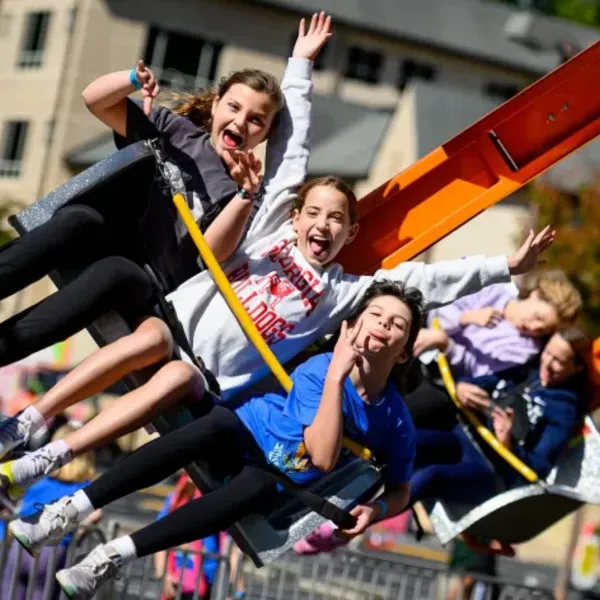 Carnival rides and games setup at an outdoor event