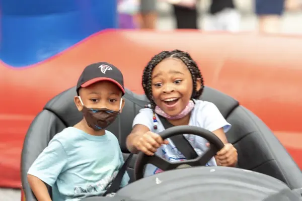 Kids riding bumper cars at an Action Packed Parties event