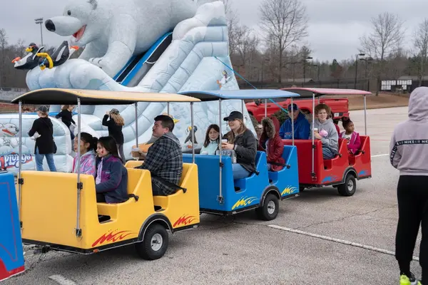 Trackless train ride with passengers at a winter event