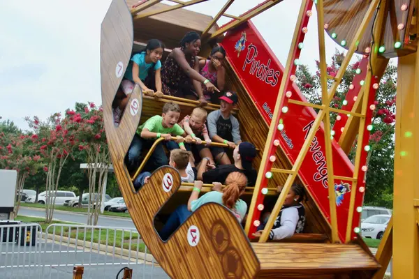 Kids and families on a Pirates Revenge swinging carnival ride