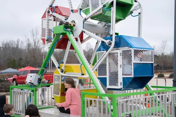 Colorful kids ferris wheel ride at a community carnival