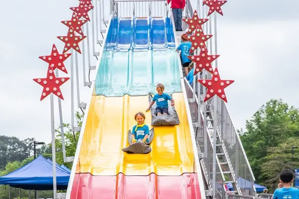 Giant inflatable slide setup at a community event