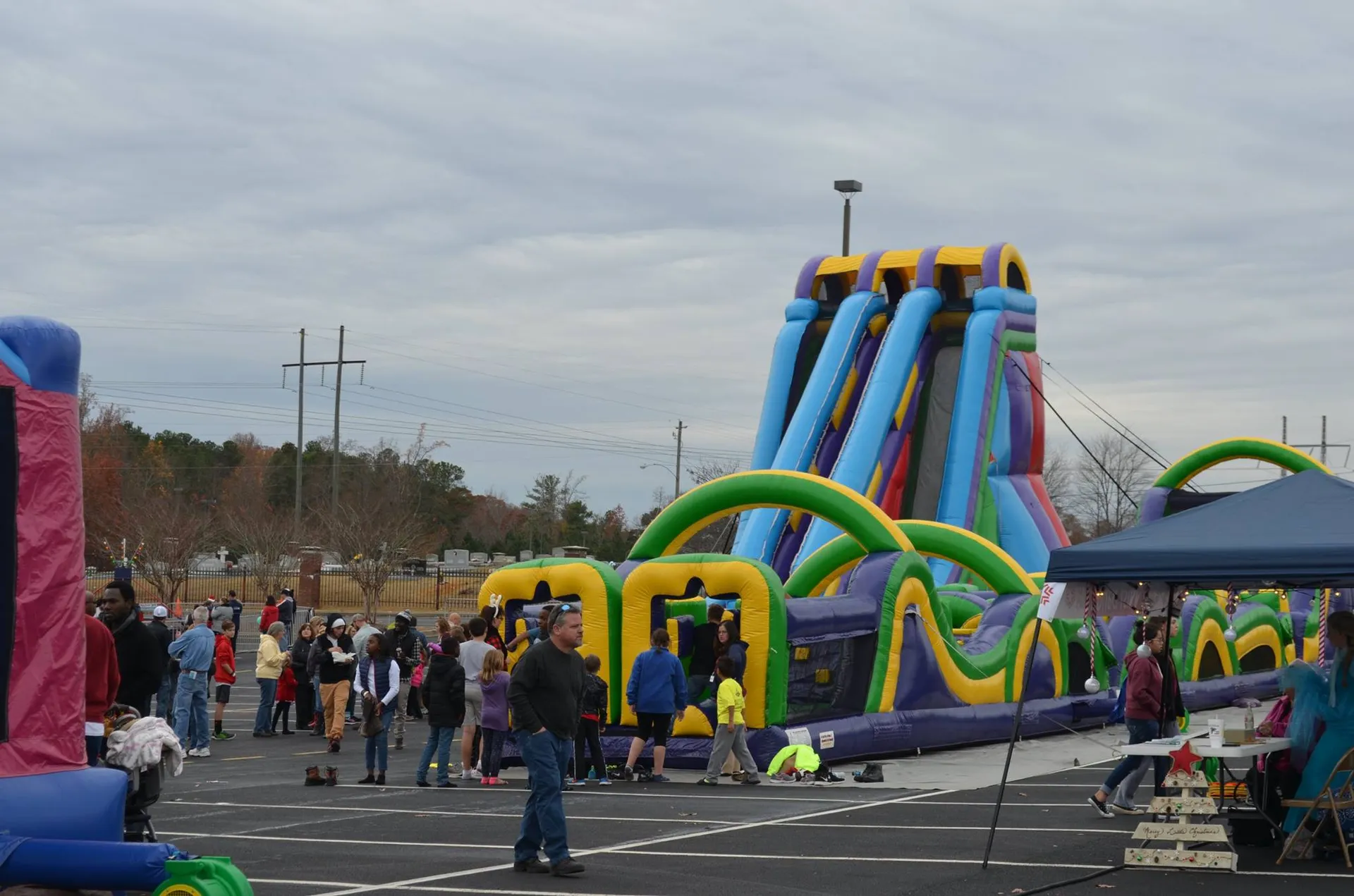 Community event featuring giant inflatable slides and obstacle courses