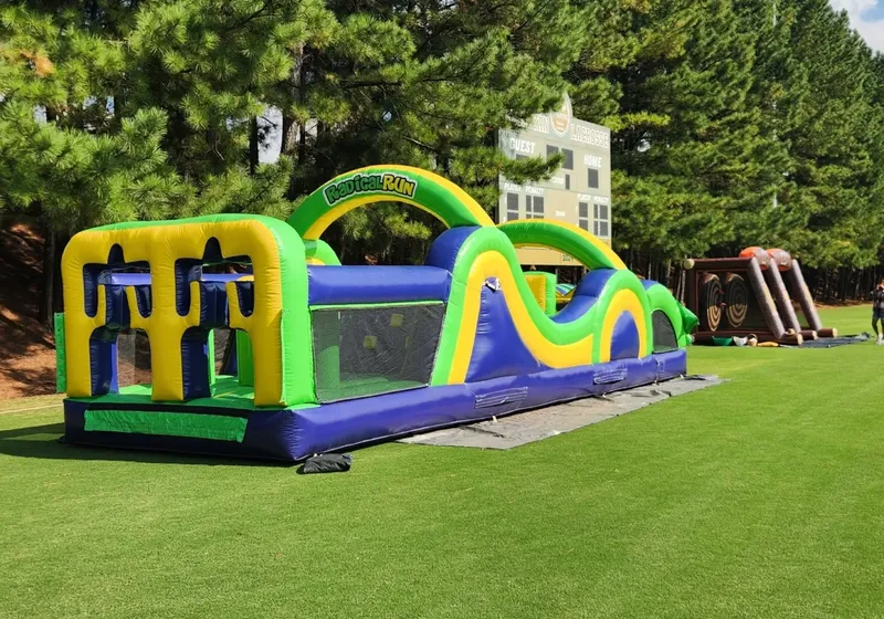 Large inflatable obstacle course set up on a green lawn